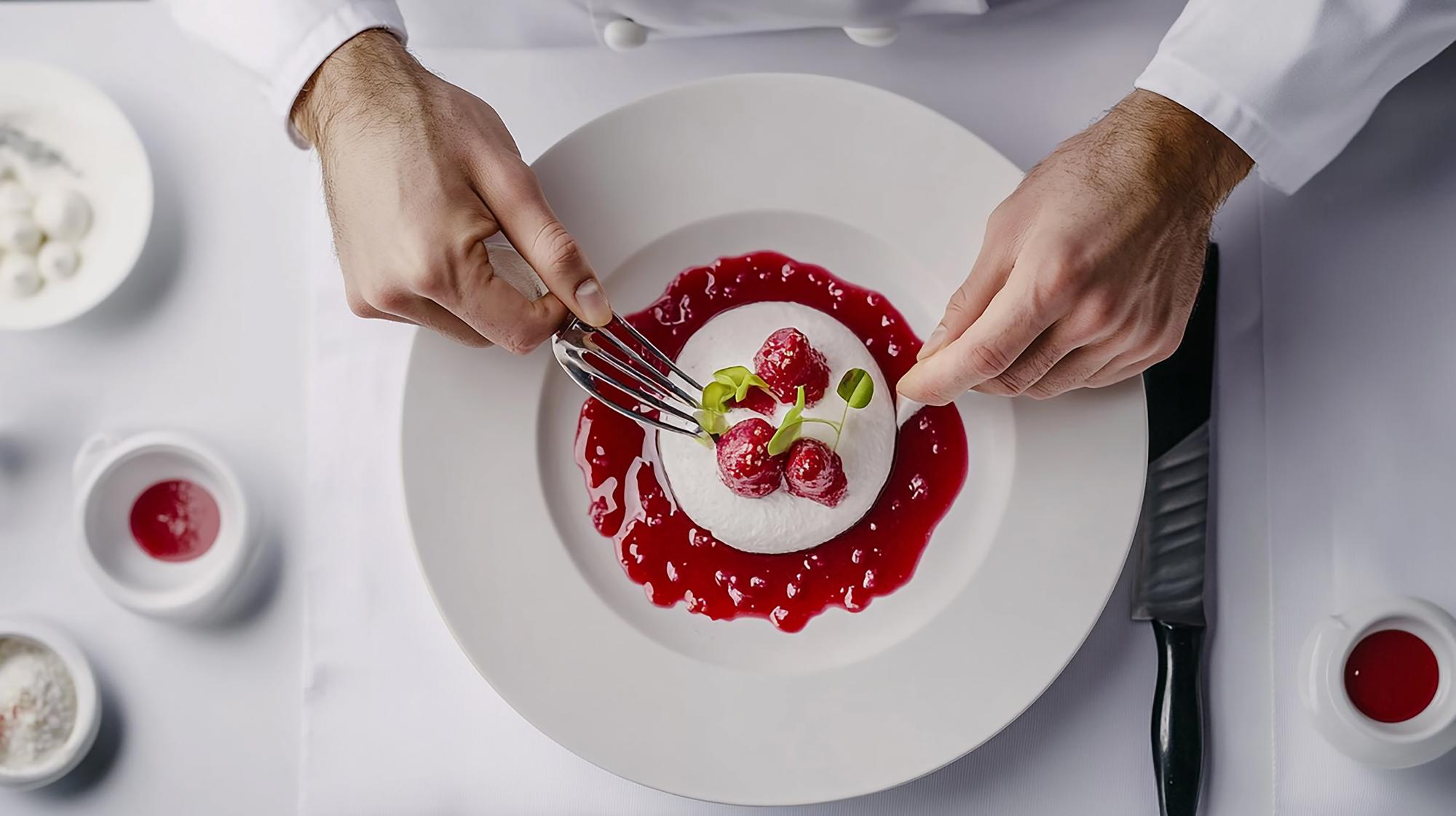 Close up of hands plating dessert
